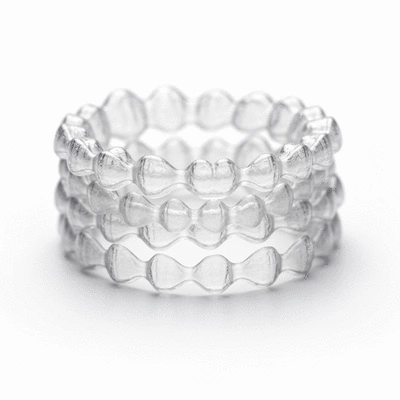Close-up of clear Invisalign aligners on a white background